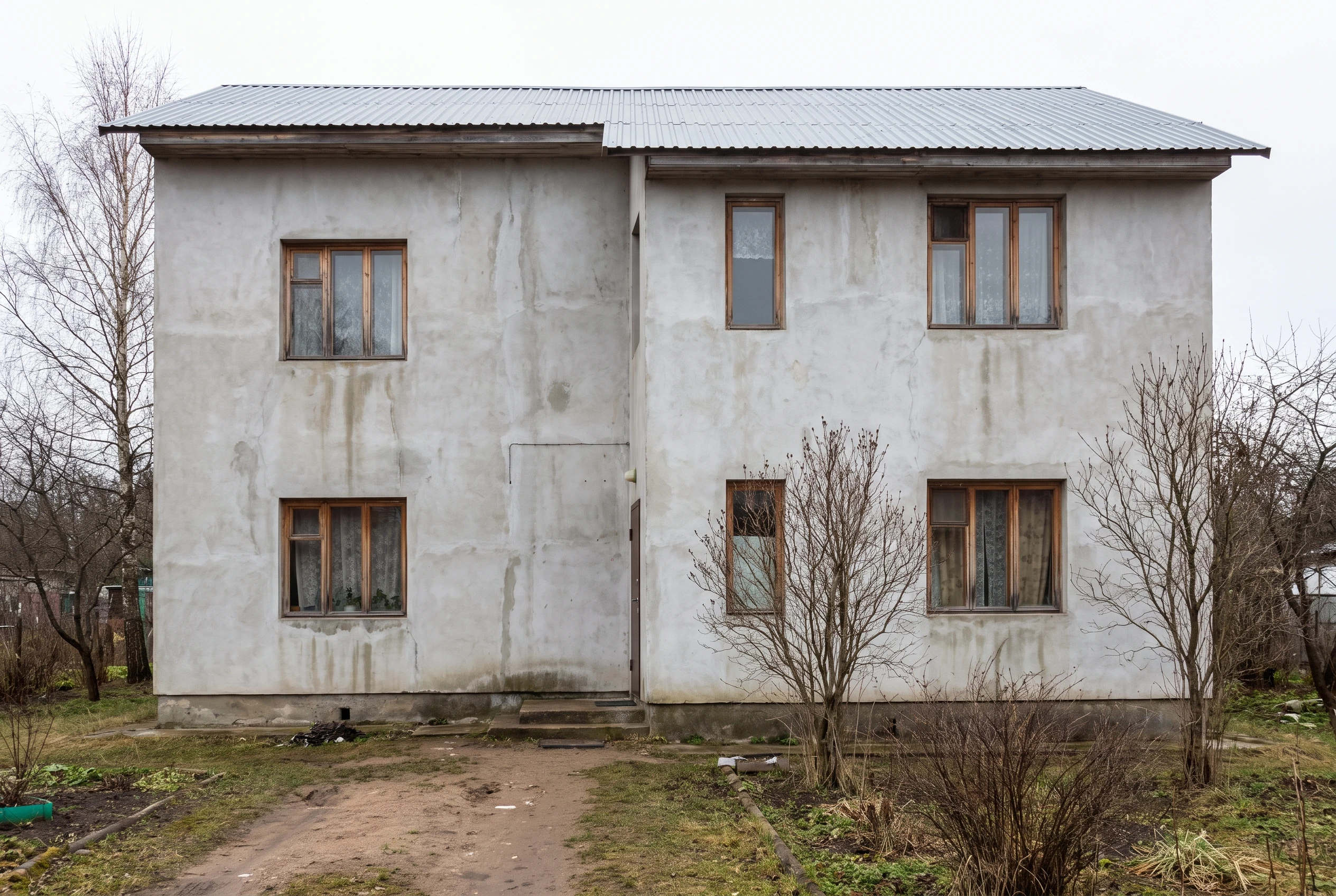 Фасад дома до покраски — выцветший серый фасад